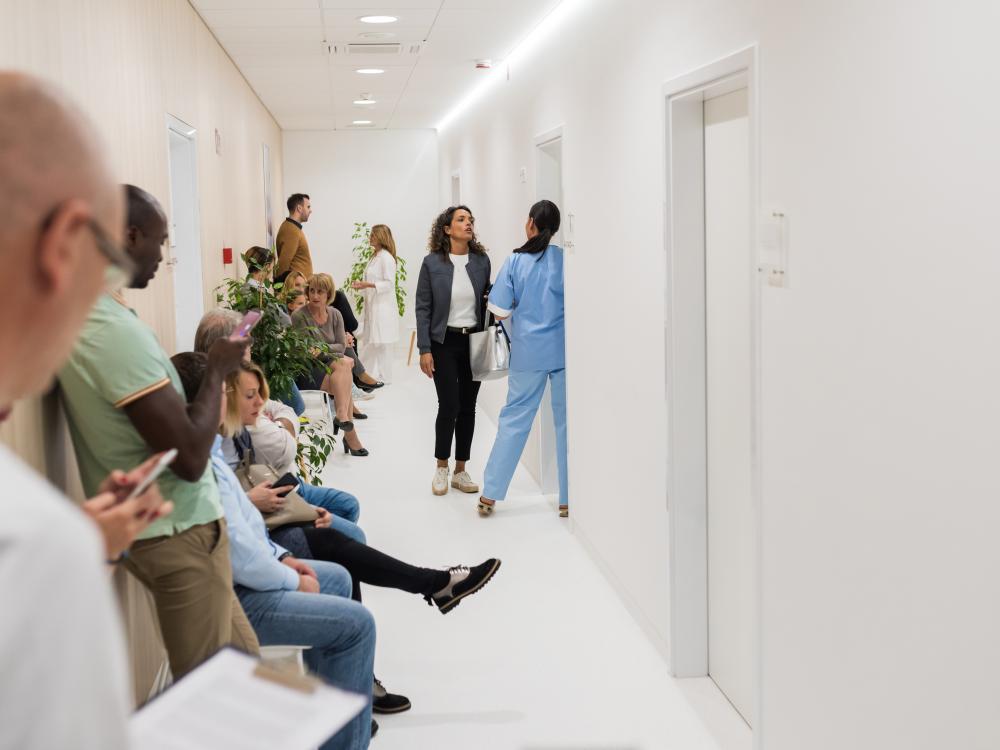 Hallway in a hospital filled with people waiting