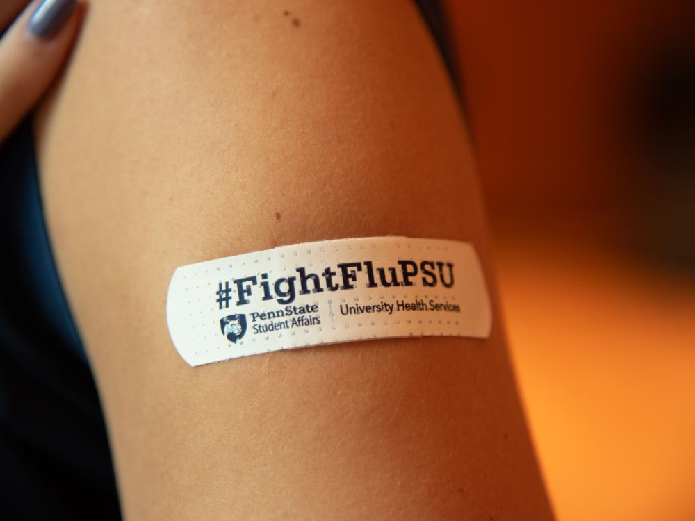 #FightFluPSU bandage on student.