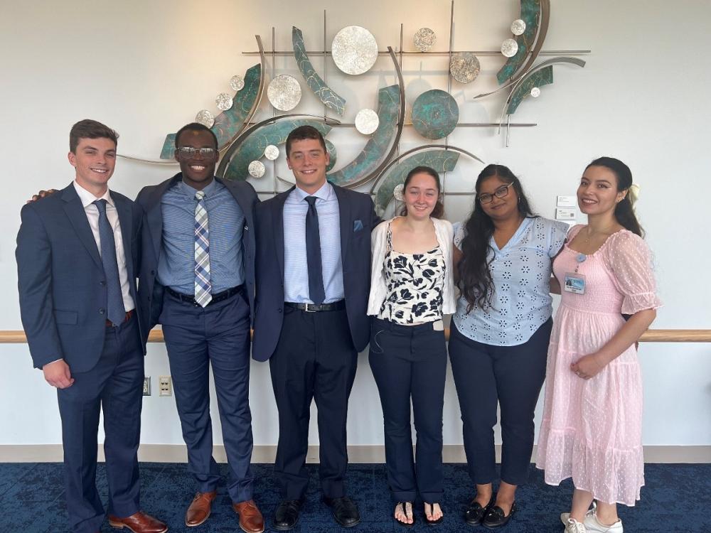 Six people pose together for a photo.