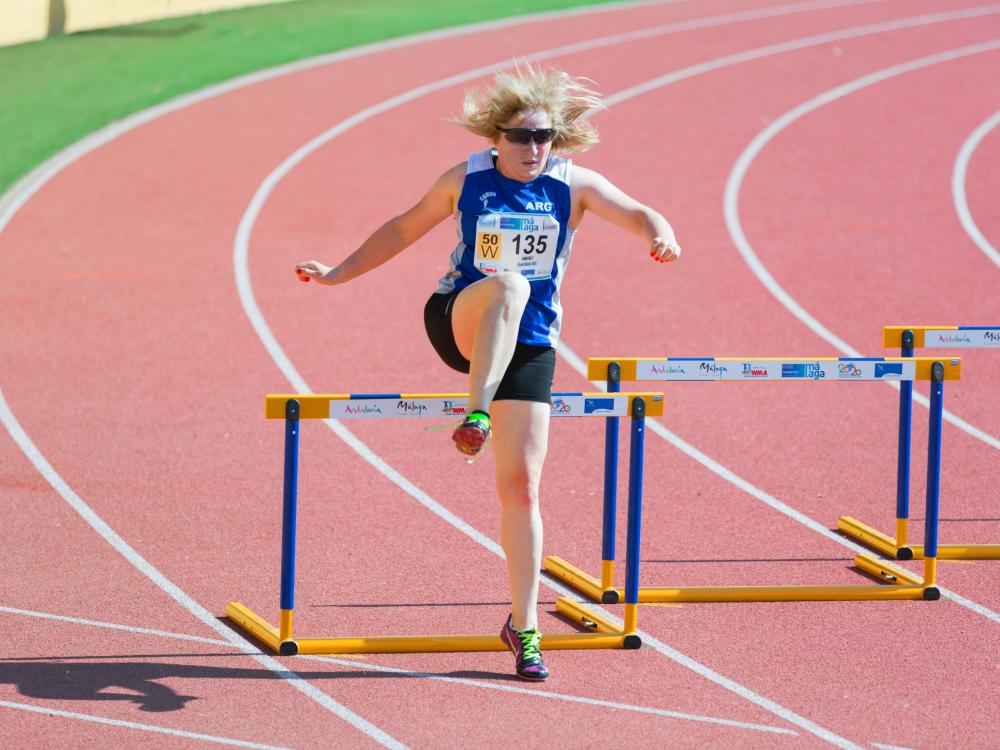 Woman jumping hurdle